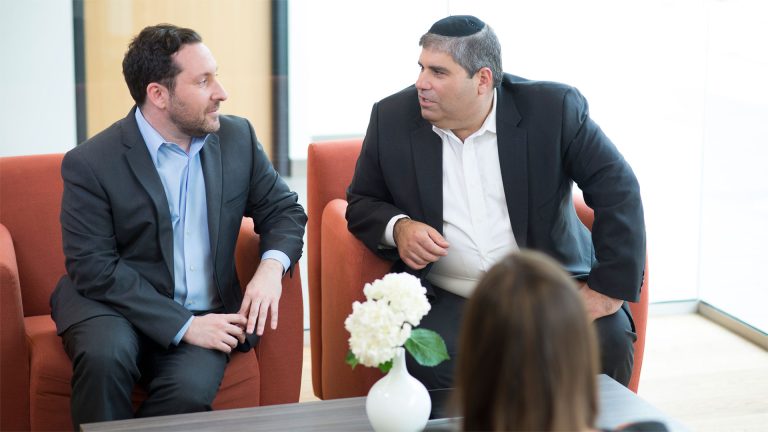 Jeremy Magence team of skilled personal injury lawyers in Toronto engaging in a professional discussion, embodying the expertise of accident law and brain injury claims at a reputable personal injury law firm.